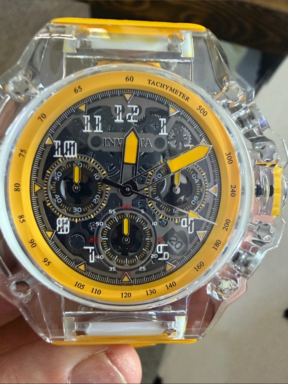 Invicta Racing quartz chronograph watch with a clear acrylic case and a vibrant
